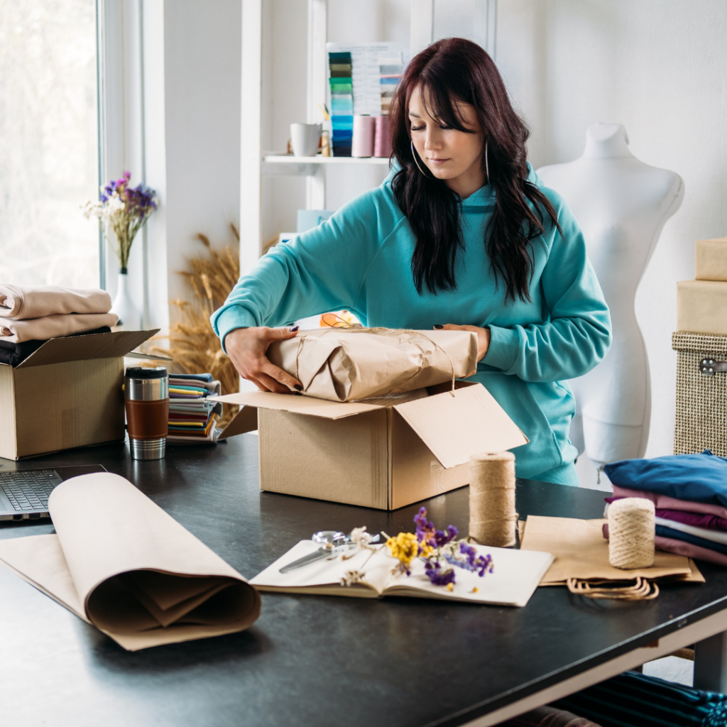 A girl wearing a jacket as she unboxes a package.