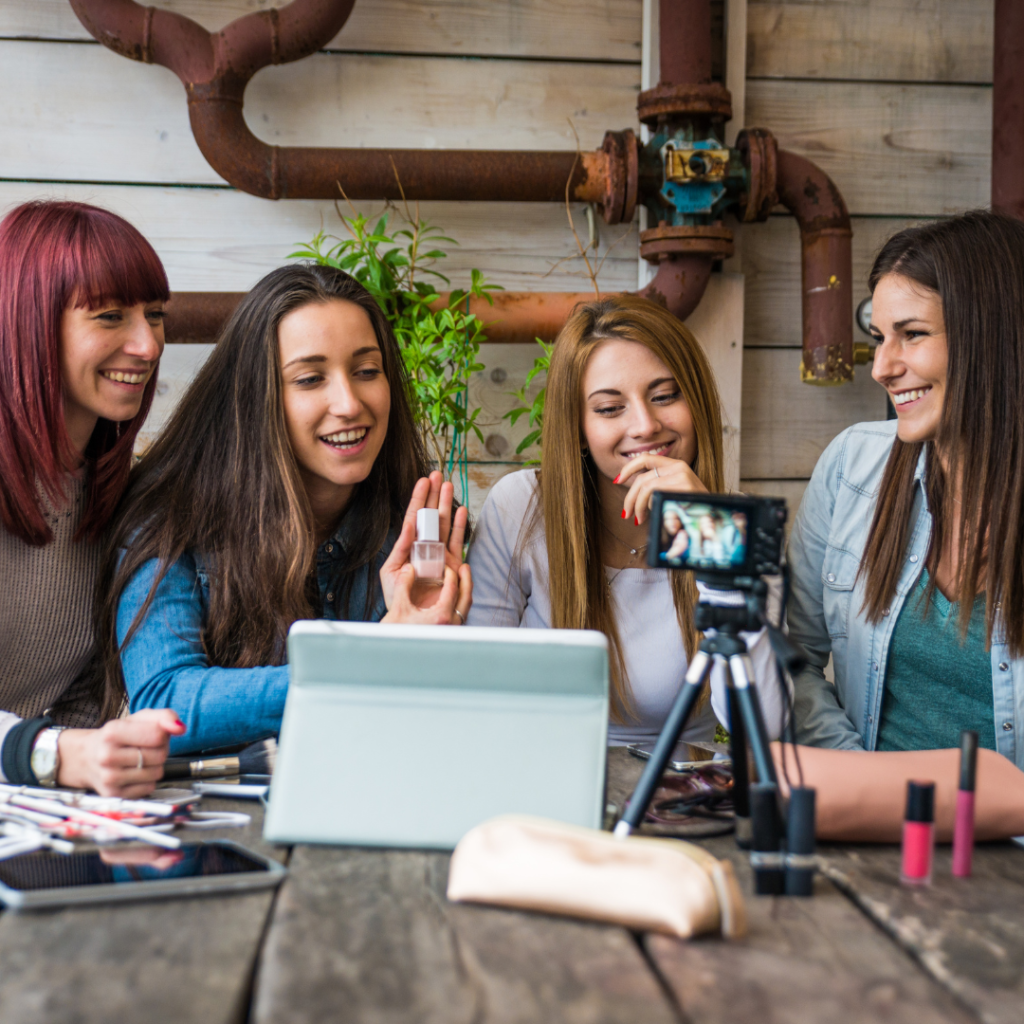 A group of girls hosts a live selling session in front of a camera.