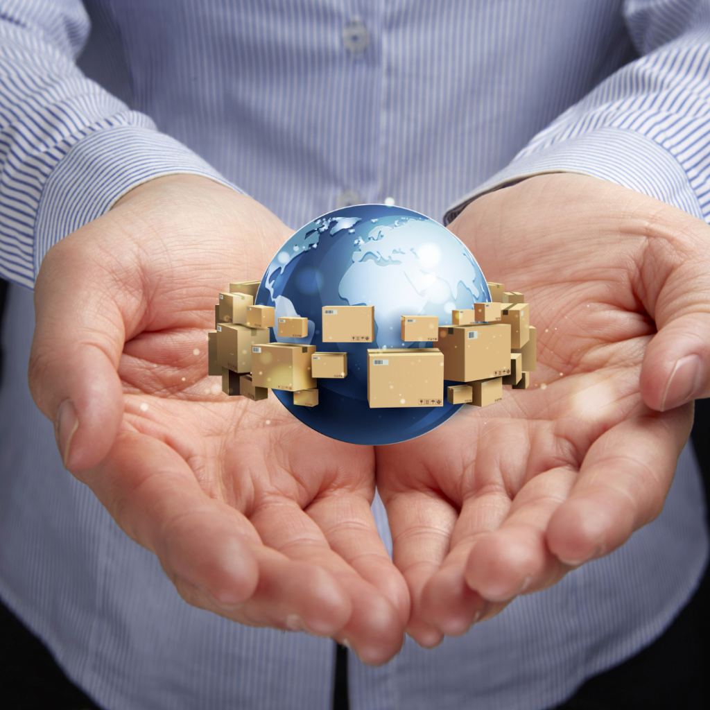 A hand holding a rotating globe surrounded by floating boxes